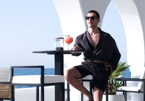 Knossos Beach Si La Restaurant visitor sitting at a table with a cocktail
