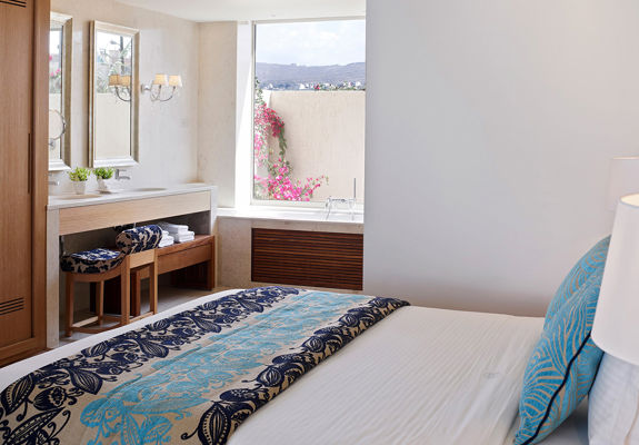 Knossos Beach Two Bedroom Suite Resort View decorated double bed and amenities