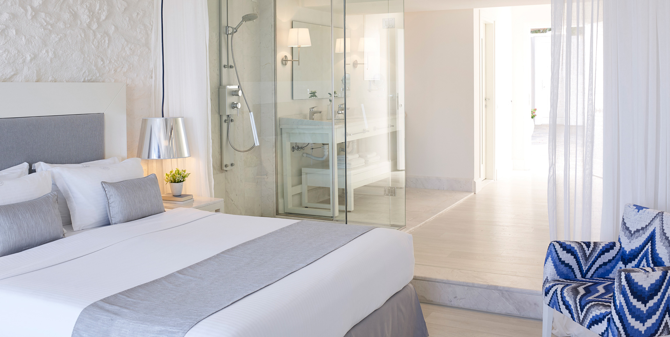 Knossos Beach Two Bedroom Suite Sea View double bed and the shower in the background