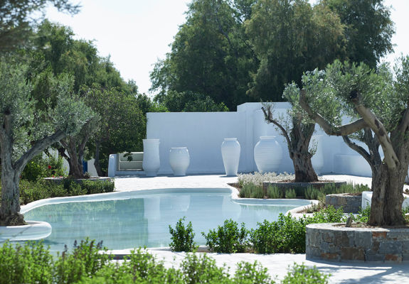 Knossos Beach garden with a pool in the middle and some white clay pots in the background