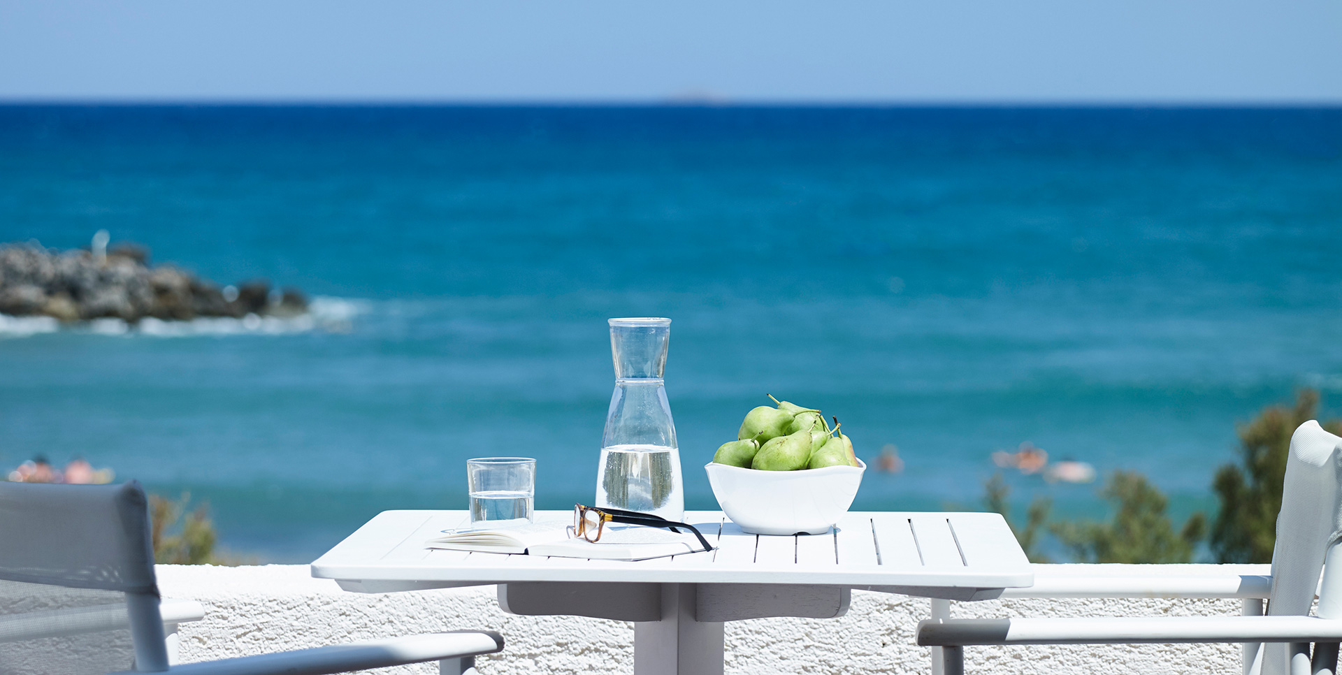 Knossos Beach Bungalow Water Front balcony table and chairs and view of the sea