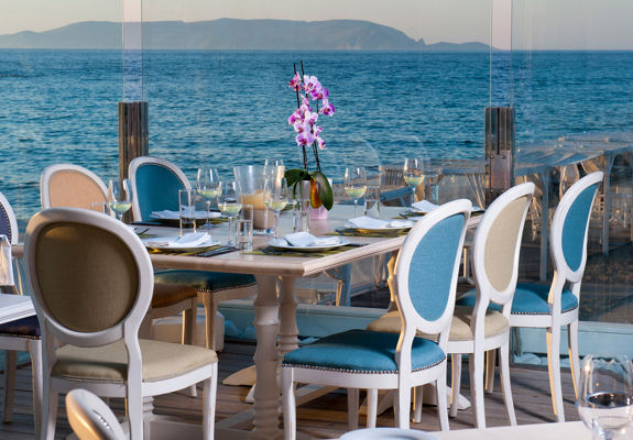 Knossos Beach Swell Restaurant outdoor sitting area with sea view