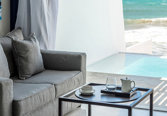 Knossos Beach Two Bedroom Suite Water Front Private Pool couch, small table and amenities
