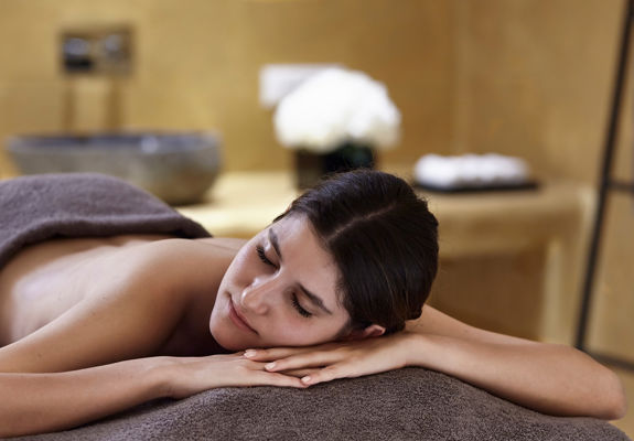 Knossos Beach Wellness Rejuvenate visitor laying on the massage bed