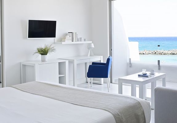Knossos Beach Two Bedroom Suite Water Front double bed, amenities and balcony view