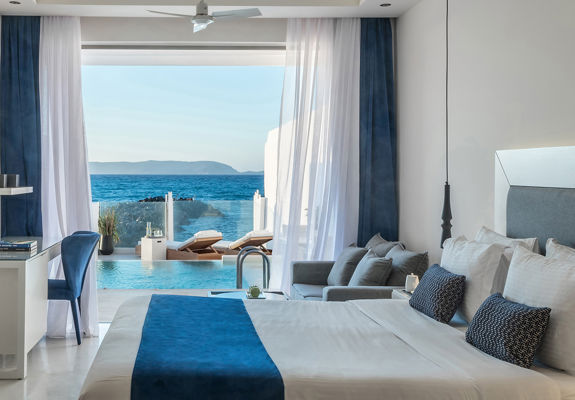 Knossos Beach Two Bedroom Suite Water Front Private Pool double bed and view of the pool