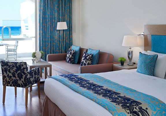 Knossos Beach Two Bedroom Spa Suite Water Front Private Pool double bed, couch, armchairs and terrace view