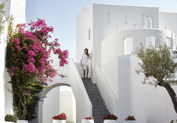 Knossos Beach garden and a visitor at the top of a staircase